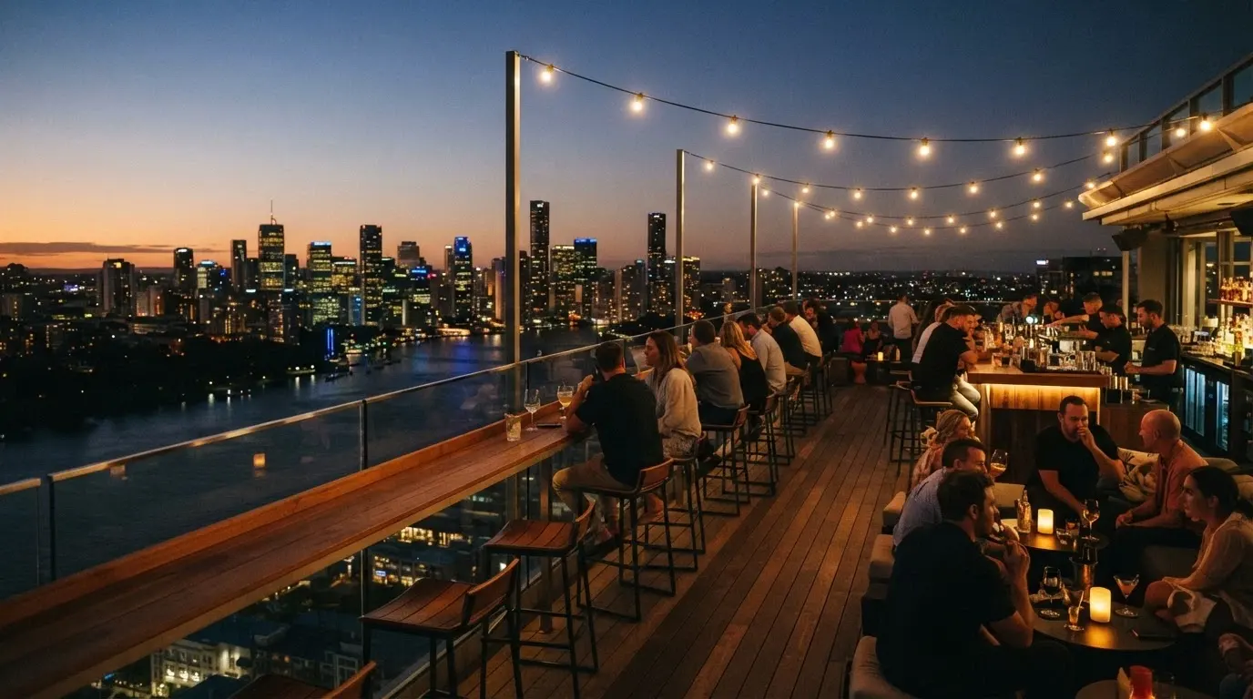 The Sky Deck at dusk with bar seating overlooking the Brisbane River and city lights